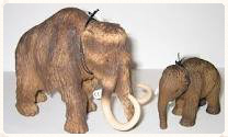 scale model of prehistoric pachyderm and a modern-day elephant