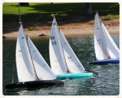 Image of scale model sailing boats afloat on a pond